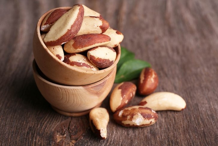 Tasty brasil nuts on wooden background