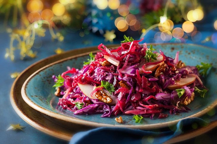 Red Cabbage salad with apples and pecan nuts for Christmas dinner. Vegetarian dish.