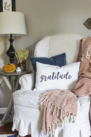 Gratitude pillow on wingback chair.