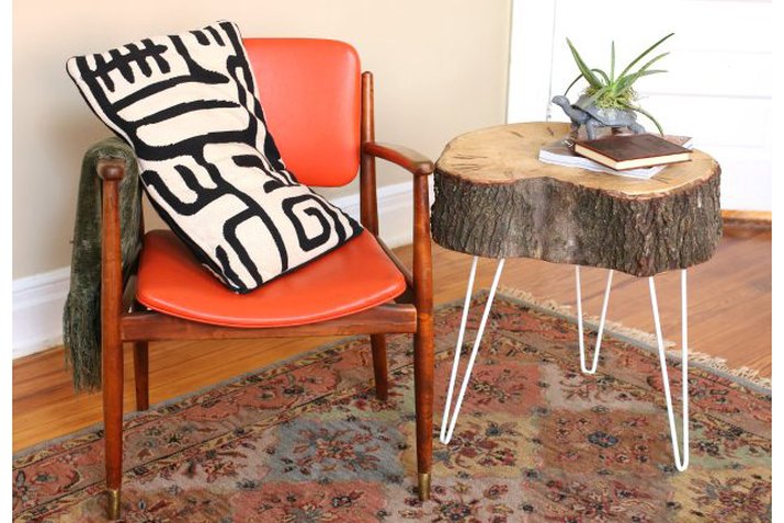tree stump end table arranged with a chair and throw pillow