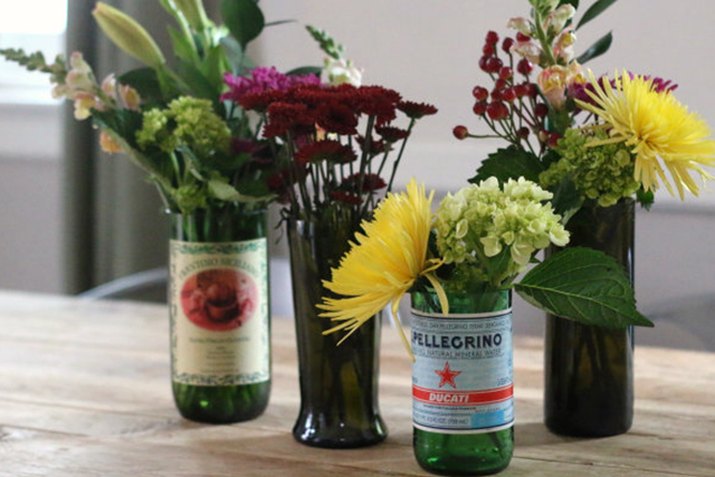 bottles cut into vases and filled with flowers