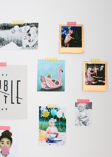 Photos on a wall with decorate tape.
