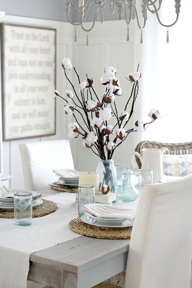 cotton branch centerpiece in middle of dining table