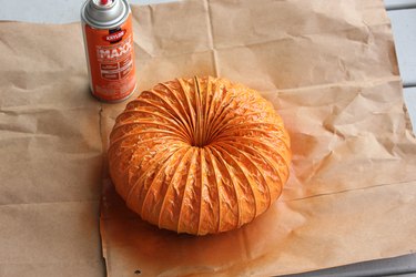 Paint the pumpkin in thin, light coats