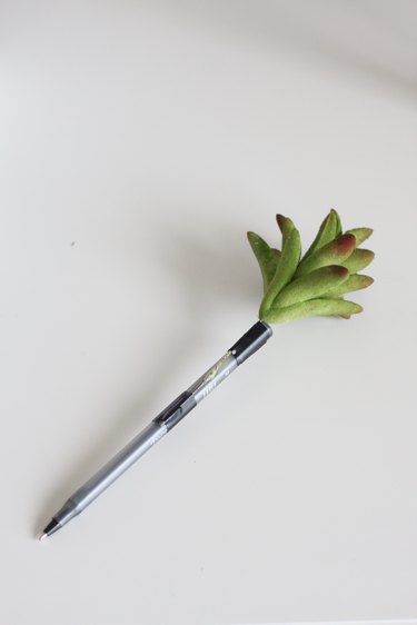 Faux succulent attached to pen