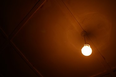 Glowing light bulb in darkness
