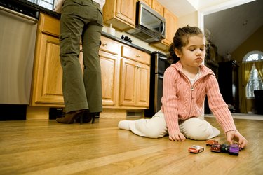Girl playing on kitchen floor