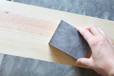 Sanding wood board to remove splinters